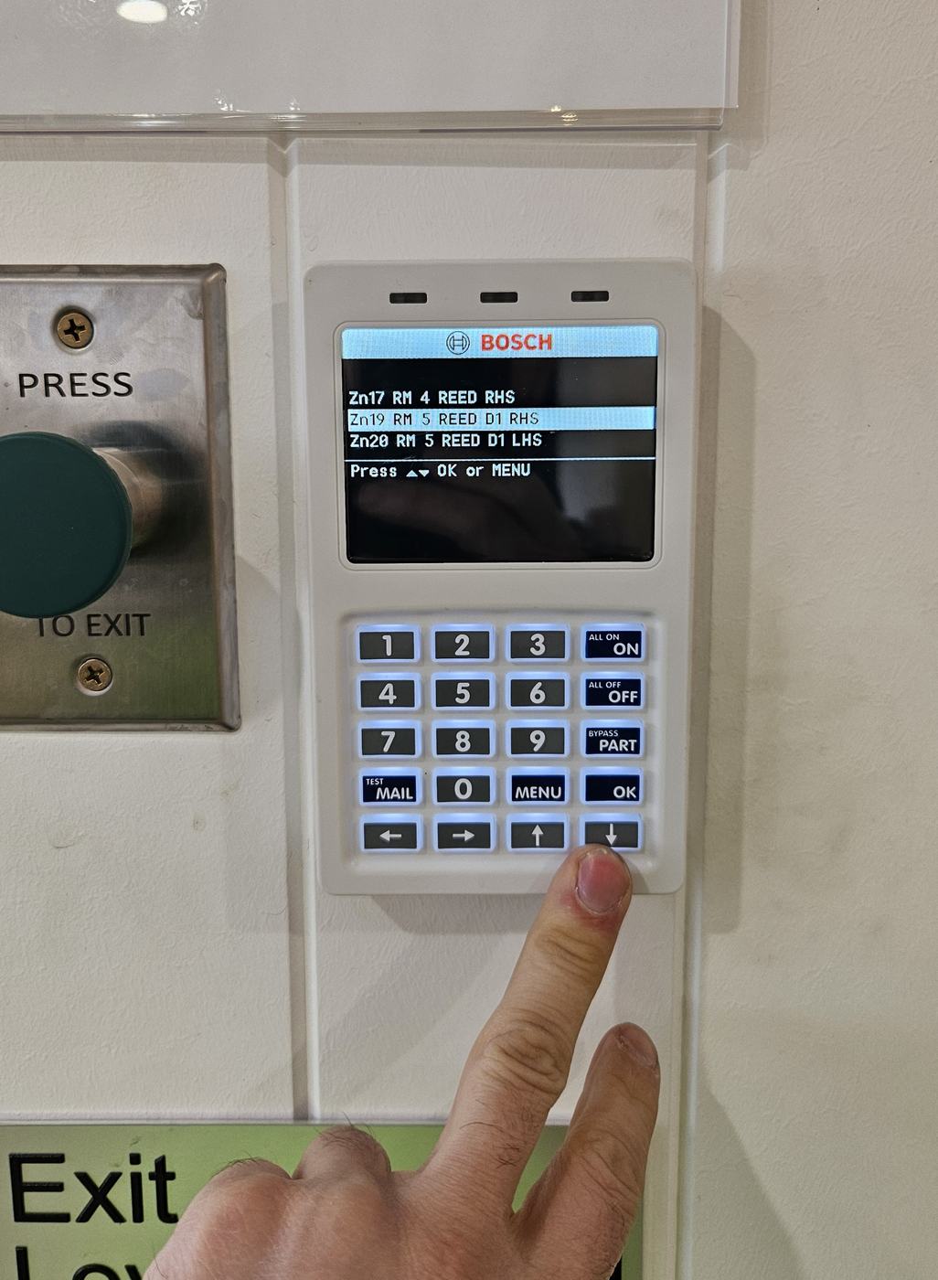 Alarm keypad and exit button at a Melbourne commercial entry