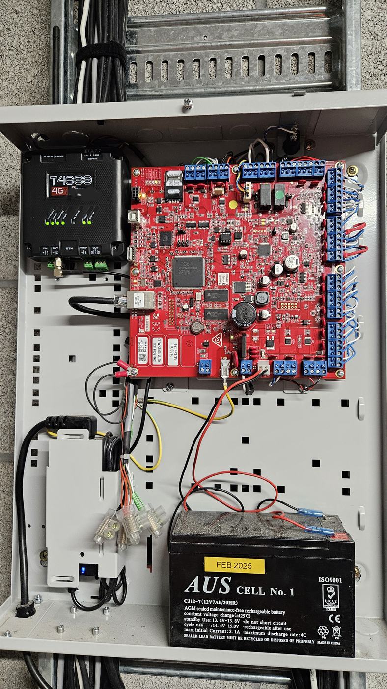 Alarm panel and backup battery inspected during a repair visit