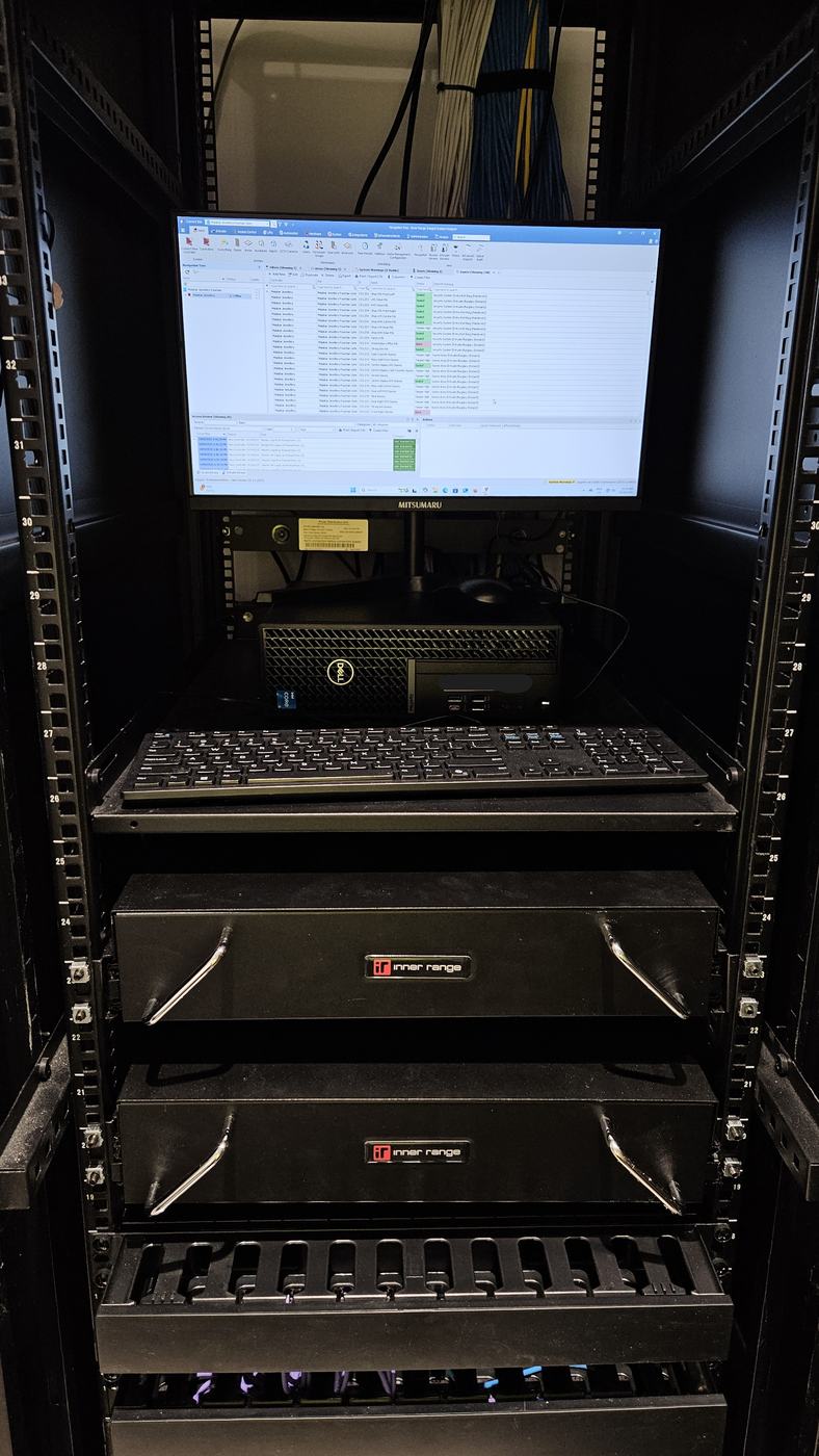 Nootz technician fault-finding an NVR in a commercial comms rack Nootz technician fault-finding an NVR in a commercial comms rack