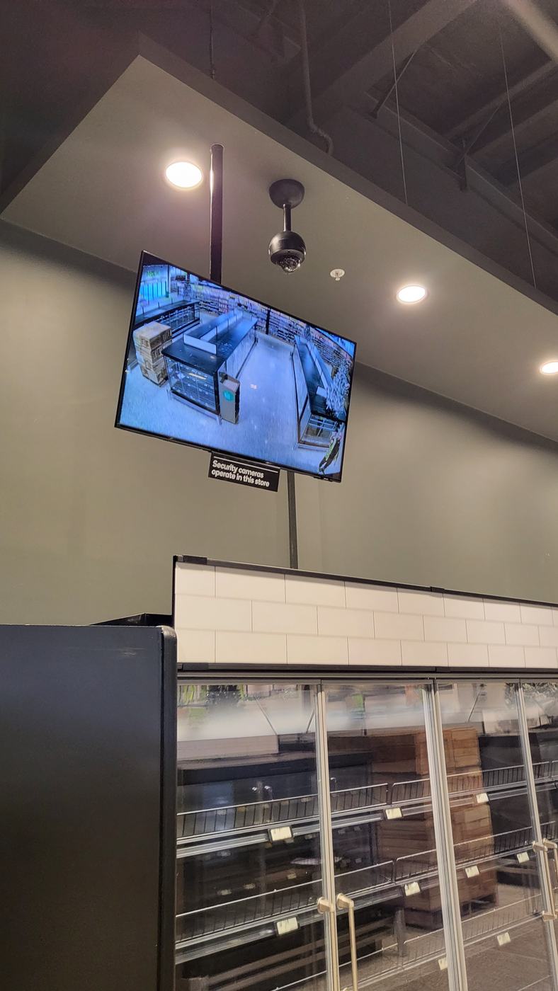 Public view monitor and CCTV camera covering a retail counter in Melbourne